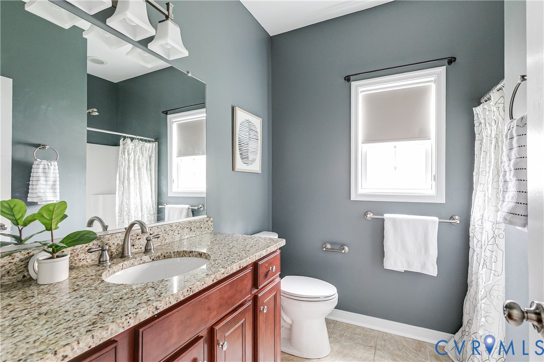 14906 Bridge Spring Drive Midlothian, VA 23113 - Photo 13 of 50 a bathroom with a granite countertop sink a toilet and a mirror