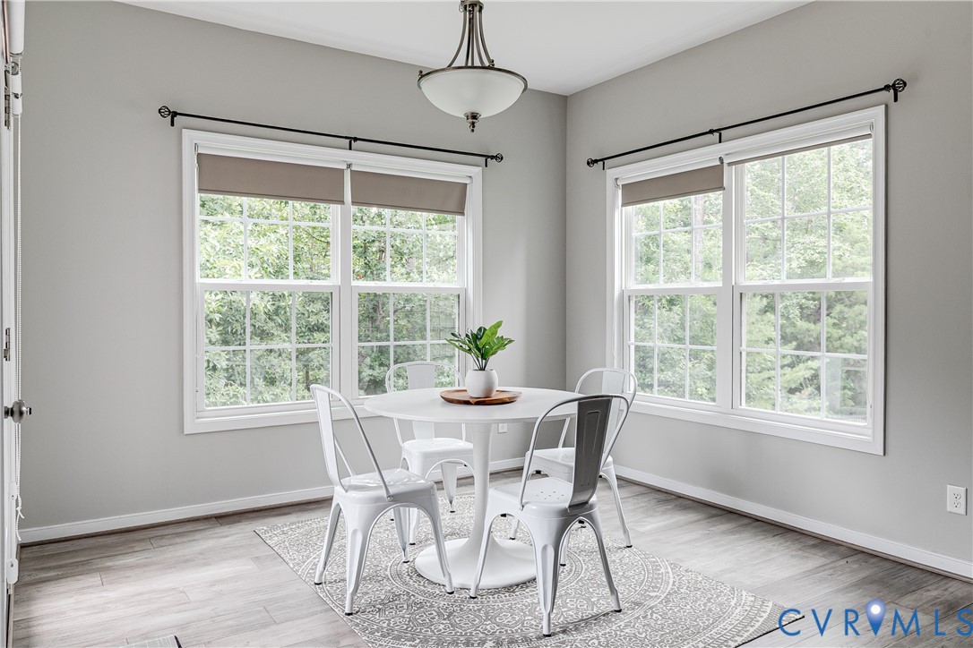 14906 Bridge Spring Drive Midlothian, VA 23113 - Photo 22 of 50 a dining room with wooden floor a chandelier and windows