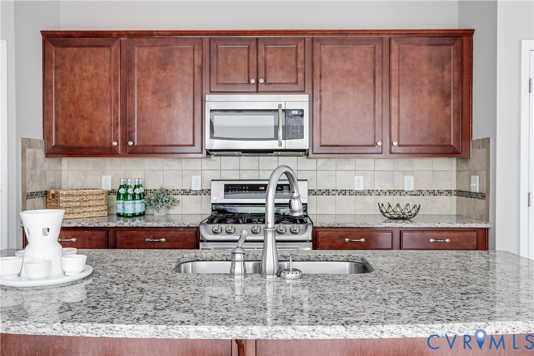 14906 Bridge Spring Drive Midlothian, VA 23113 - Photo 26 of 50 a kitchen with stainless steel appliances granite countertop a sink and cabinets