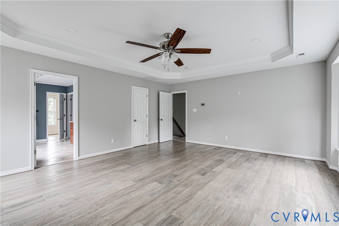14906 Bridge Spring Drive Midlothian, VA 23113 - Photo 35 of 50 a view of an empty room with wooden floor and a ceiling fan