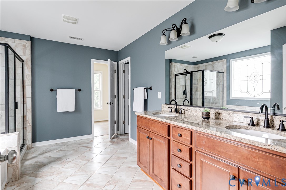 14906 Bridge Spring Drive Midlothian, VA 23113 - Photo 36 of 50 a spacious bathroom with a double vanity sink mirror and