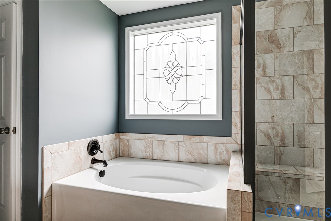 14906 Bridge Spring Drive Midlothian, VA 23113 - Photo 38 of 50 a bathroom with a bathtub and window