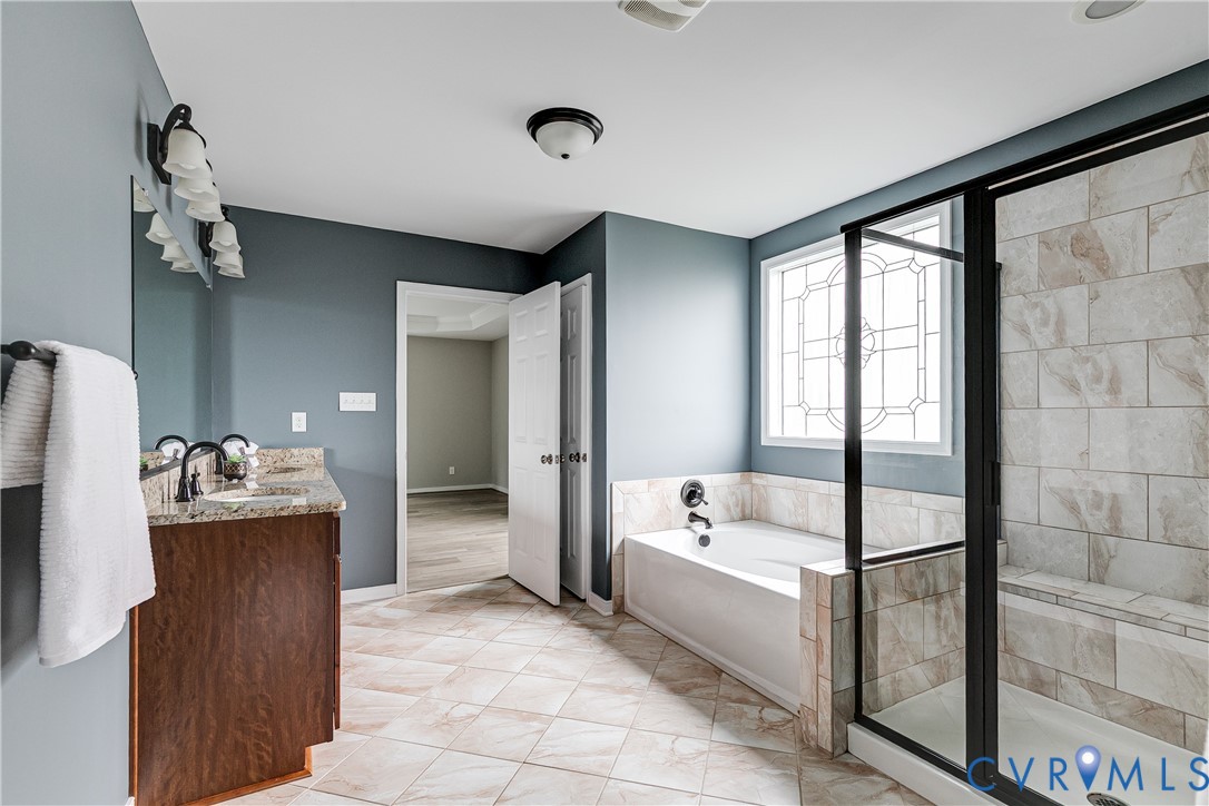 14906 Bridge Spring Drive Midlothian, VA 23113 - Photo 40 of 50 a bathroom with a tub sink and mirror