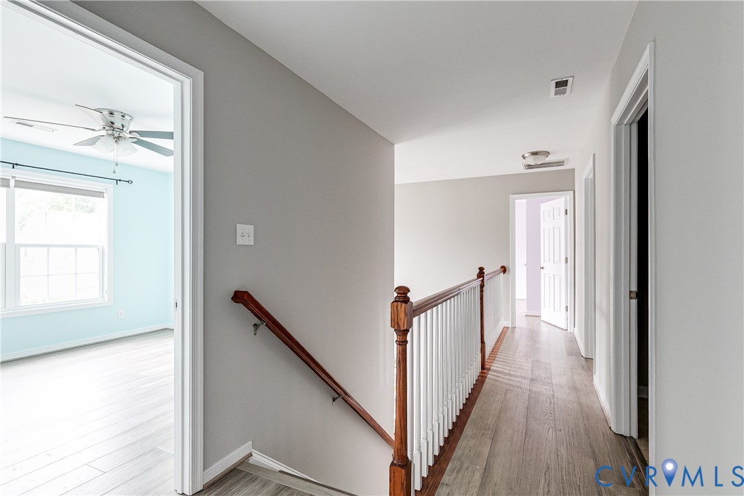 14906 Bridge Spring Drive Midlothian, VA 23113 - Photo 41 of 50 a view of a hallway view with wooden floor and staircase