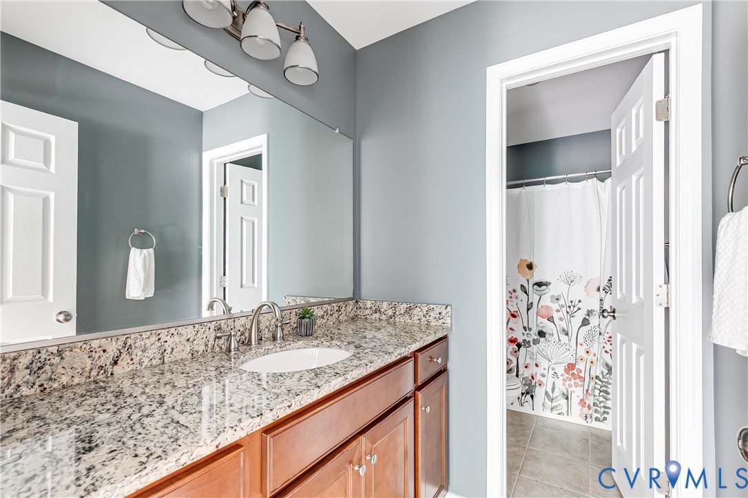 14906 Bridge Spring Drive Midlothian, VA 23113 - Photo 42 of 50 a bathroom with a granite countertop sink and a mirror