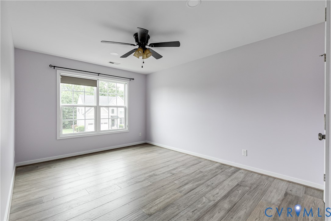 14906 Bridge Spring Drive Midlothian, VA 23113 - Photo 45 of 50 a view of an empty room with wooden floor and a window
