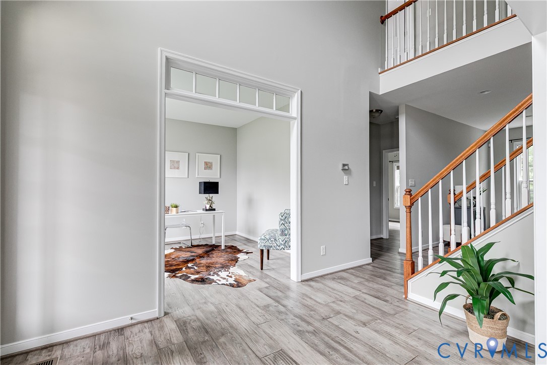 14906 Bridge Spring Drive Midlothian, VA 23113 - Photo 5 of 50 a view of a hallway with wooden floor and a potted plant