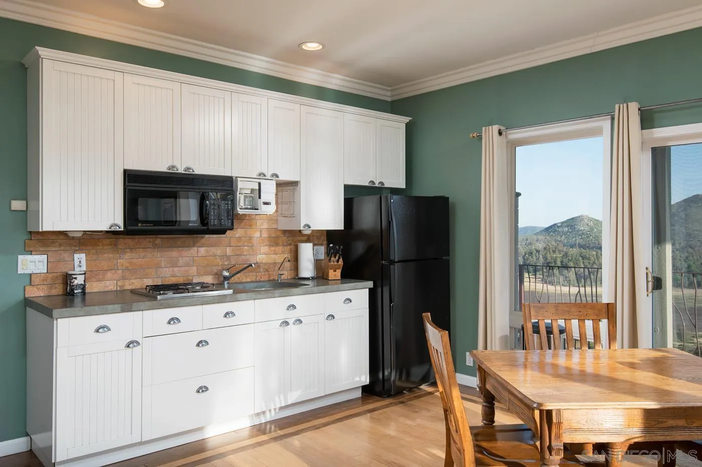 34896 Yuma Road Julian, CA 92036 - Photo 20 of 56 a kitchen with stainless steel appliances granite countertop a refrigerator a stove a sink a dining table and chairs