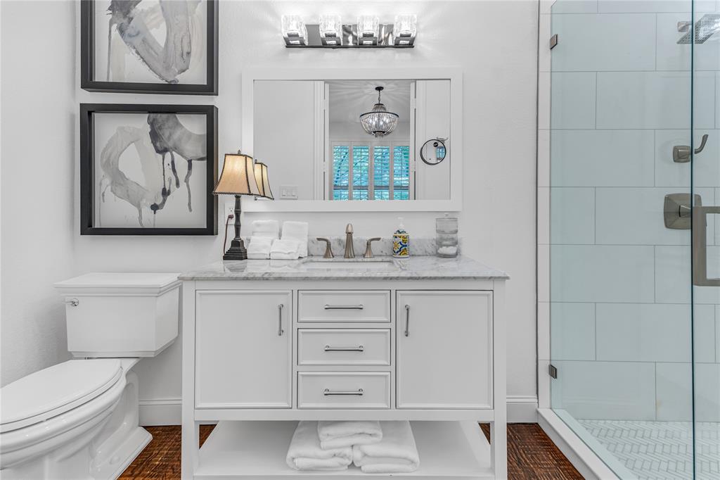 5744 Robbie Road Plano, TX 75024 - Photo 5 of 32 White vanity with a stone countertop, chrome fixtures, and a frameless glass shower enclosure