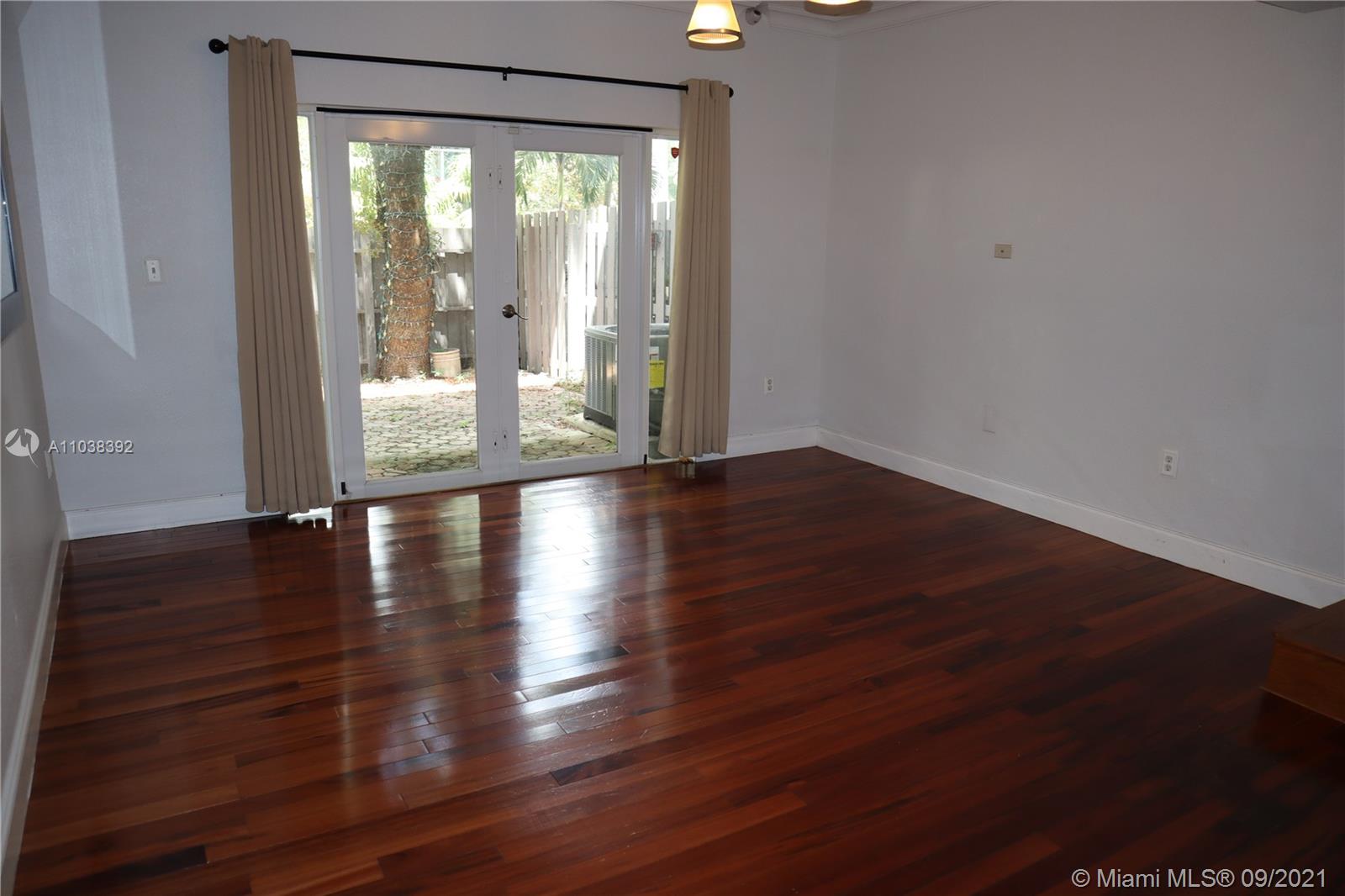 123 Southwest 17th Road Miami, FL 33129 - Photo 11 of 28 a view of an empty room with wooden floor and a window