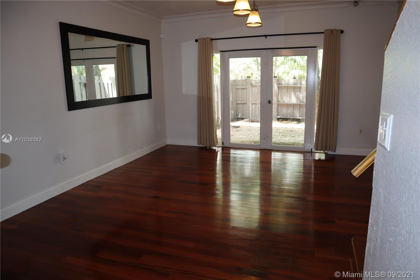 123 Southwest 17th Road Miami, FL 33129 - Photo 12 of 28 a view of empty room with wooden floor and fan