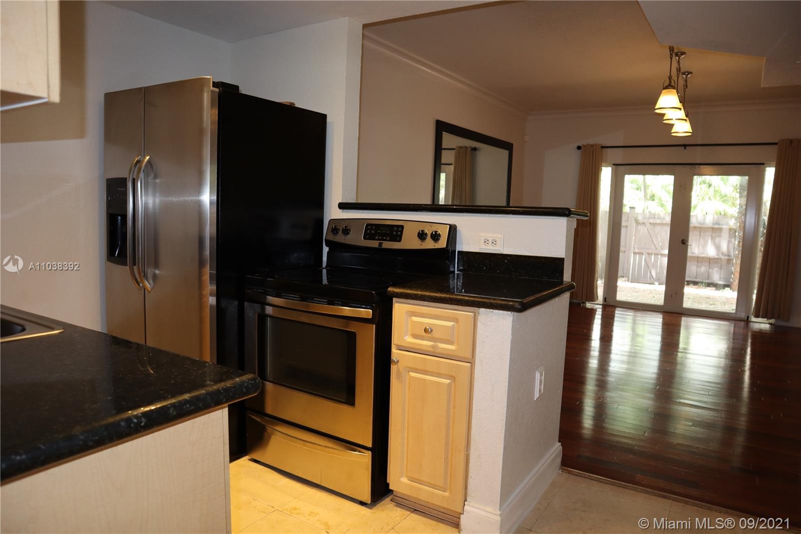123 Southwest 17th Road Miami, FL 33129 - Photo 13 of 28 a kitchen with stainless steel appliances granite countertop a refrigerator and a stove