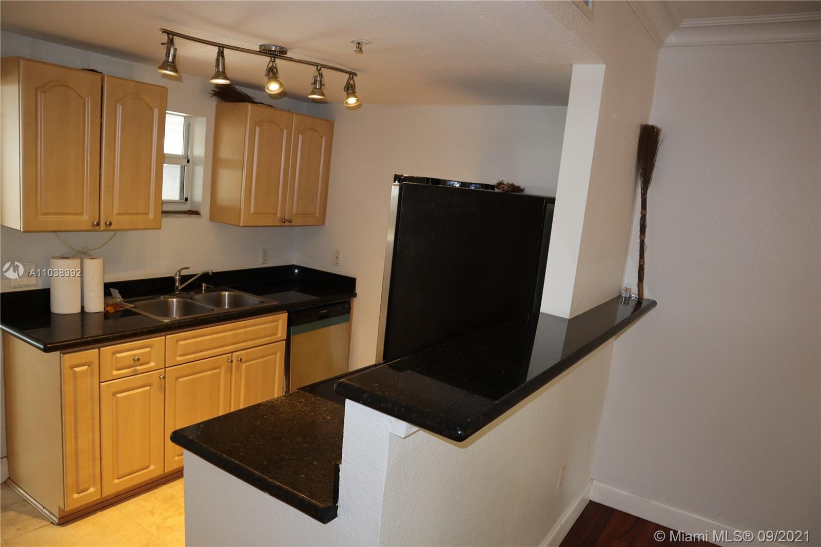 123 Southwest 17th Road Miami, FL 33129 - Photo 15 of 28 a kitchen with granite countertop white cabinets and stainless steel appliances
