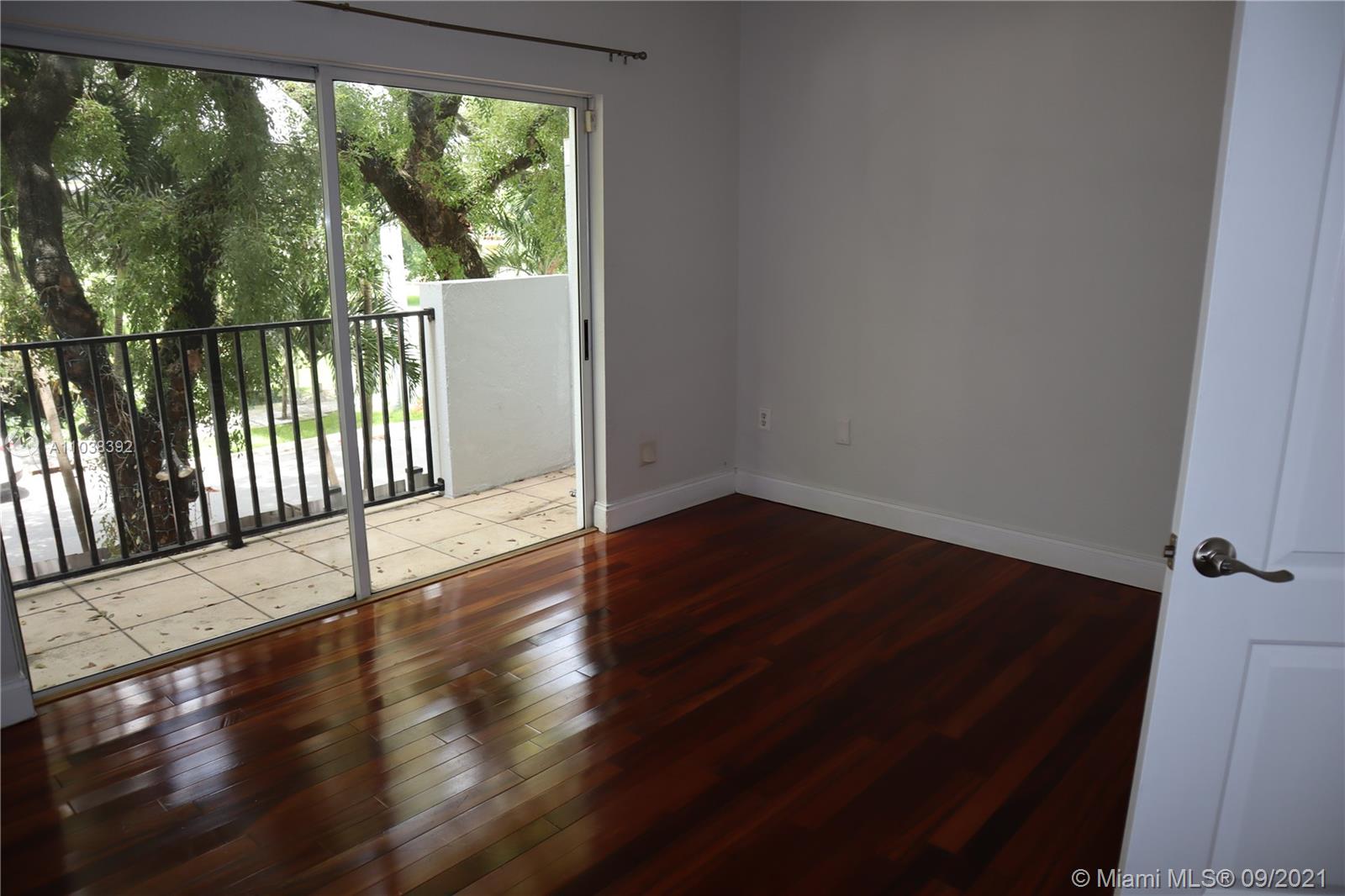 123 Southwest 17th Road Miami, FL 33129 - Photo 20 of 28 a view of a black and white floor to ceiling window with wooden floor