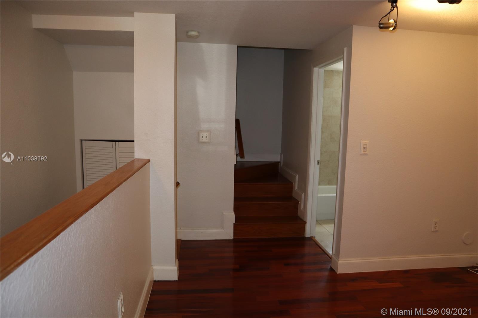 123 Southwest 17th Road Miami, FL 33129 - Photo 21 of 28 a view of a hallway with wooden floor and staircase
