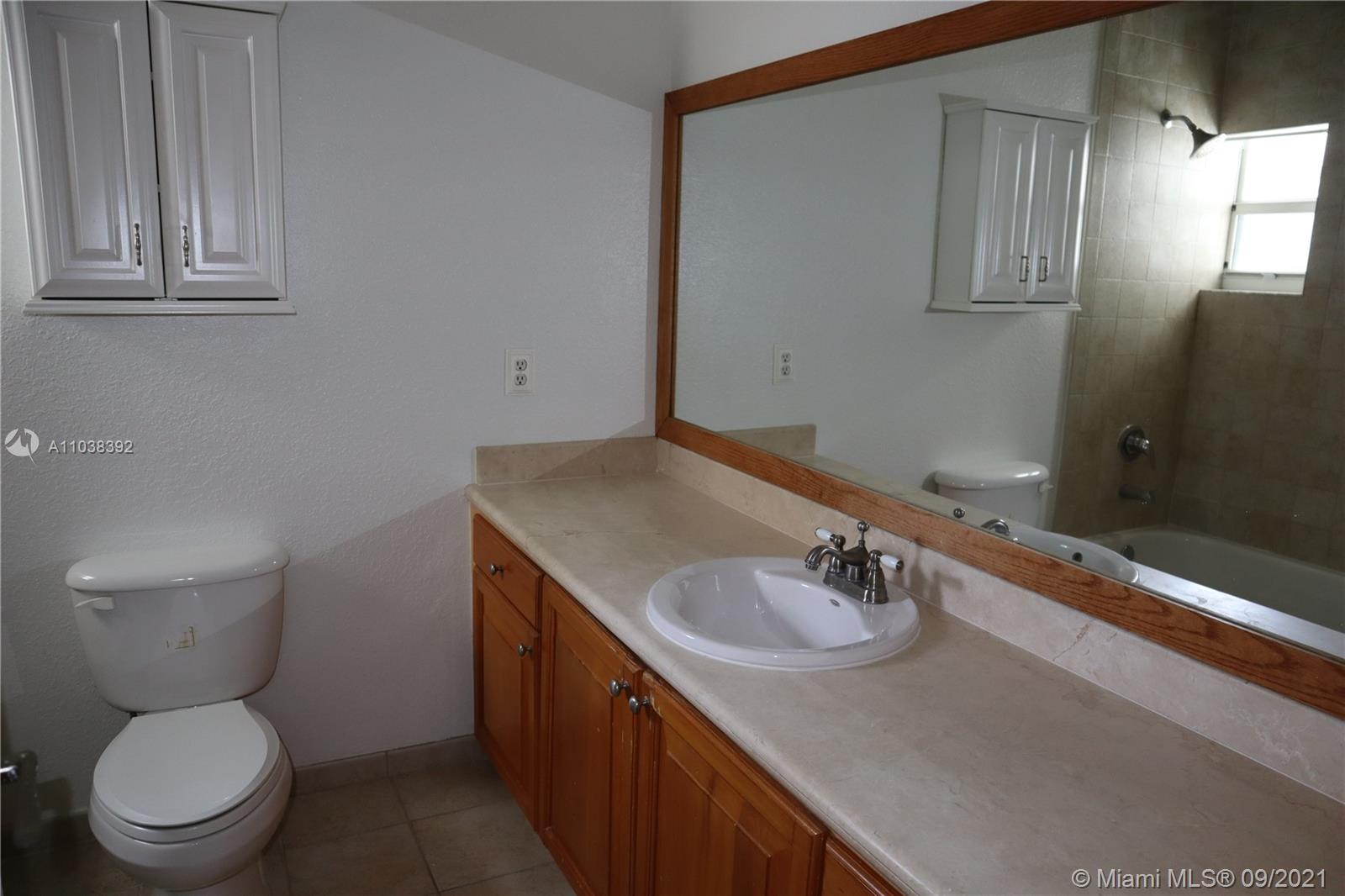 123 Southwest 17th Road Miami, FL 33129 - Photo 22 of 28 a bathroom with a sink a toilet and a mirror