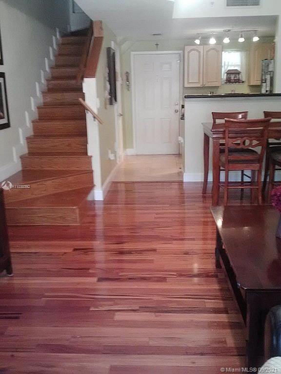 123 Southwest 17th Road Miami, FL 33129 - Photo 5 of 28 a view of a hallway with wooden floor and staircase