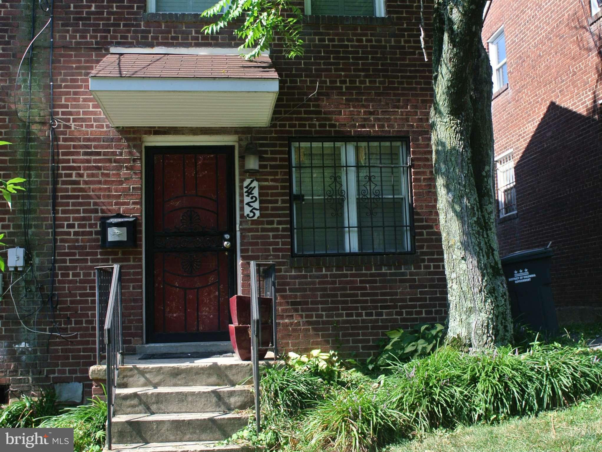1425 Howard Road Southeast Washington, DC 20020 - Photo 2 of 13 a front view of a house with plants