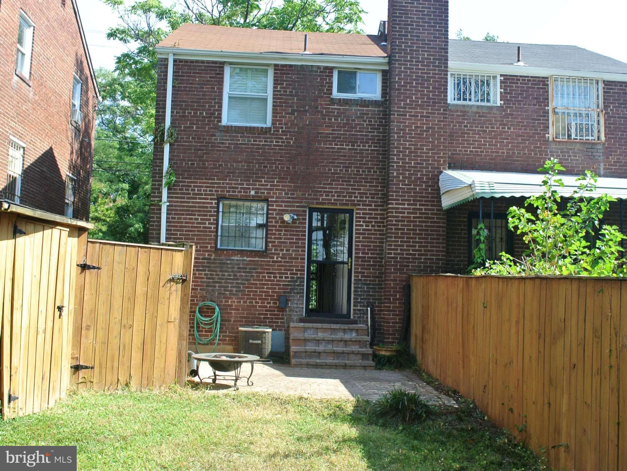 1425 Howard Road Southeast Washington, DC 20020 - Photo 11 of 13 a backyard of a house with table and chairs