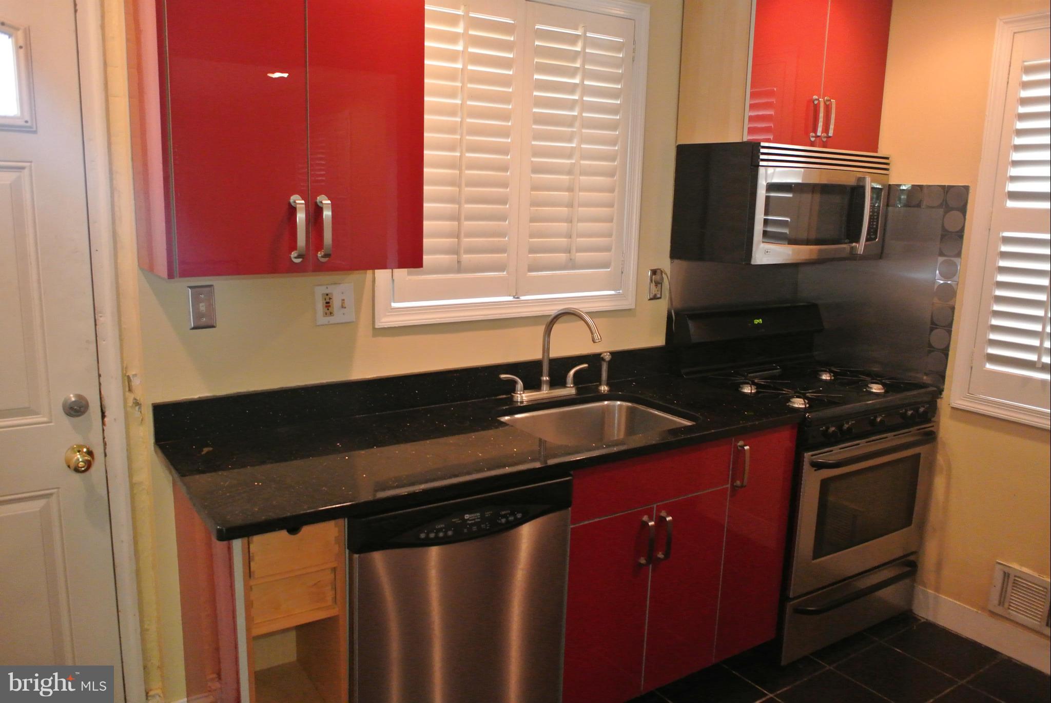 1425 Howard Road Southeast Washington, DC 20020 - Photo 5 of 13 a kitchen with a sink stove and microwave