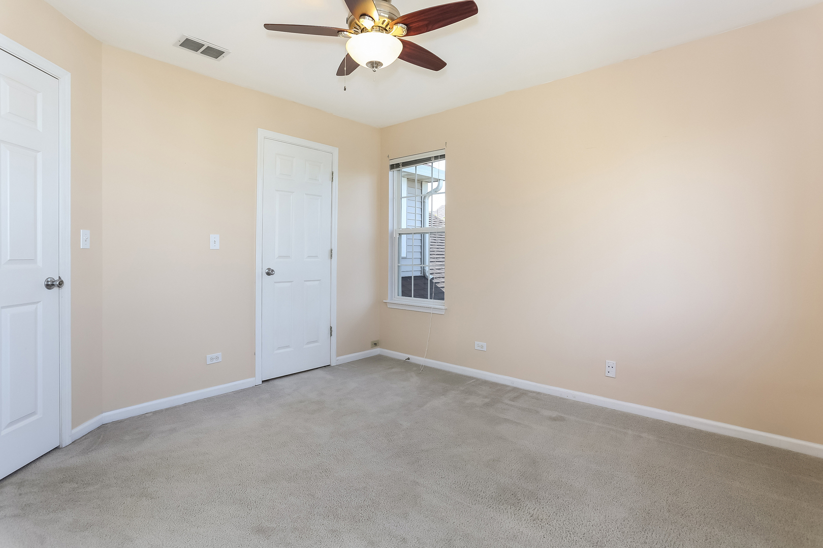 5460 Sullivan Pass Lake In The Hills, IL 60156 - Photo 32 of 51 an empty room with a window and a fan