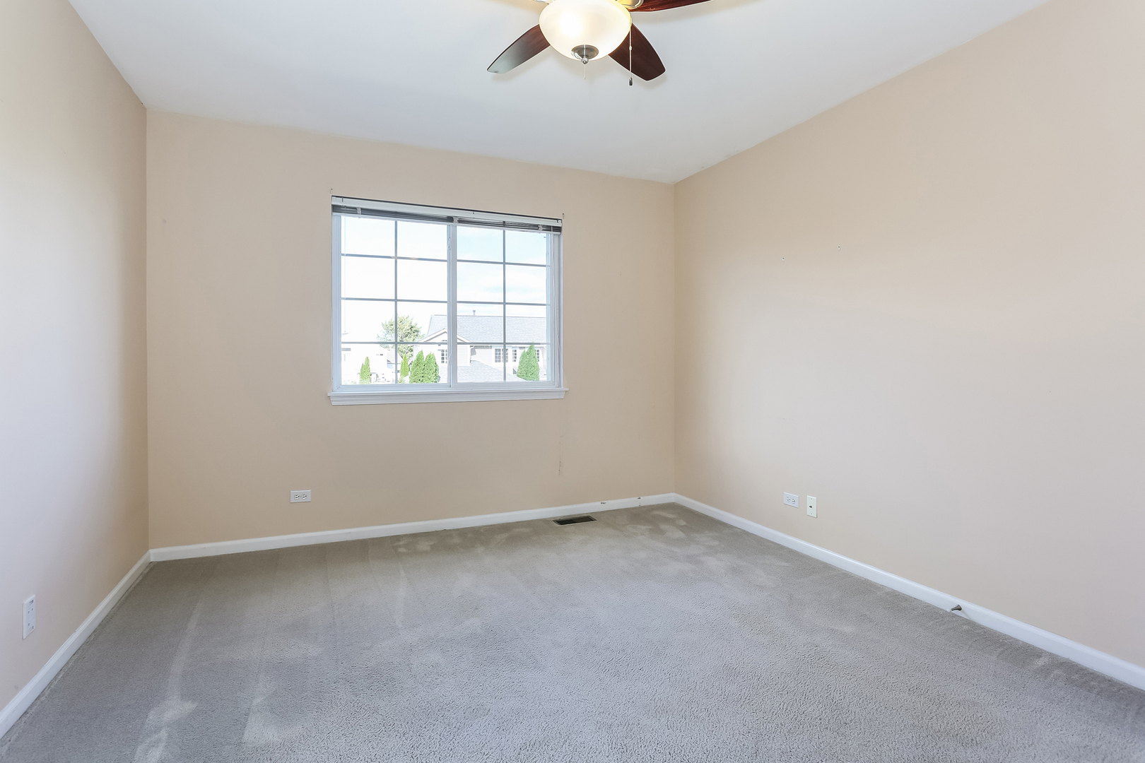 5460 Sullivan Pass Lake In The Hills, IL 60156 - Photo 33 of 51 an empty room with a window and a ceiling fan