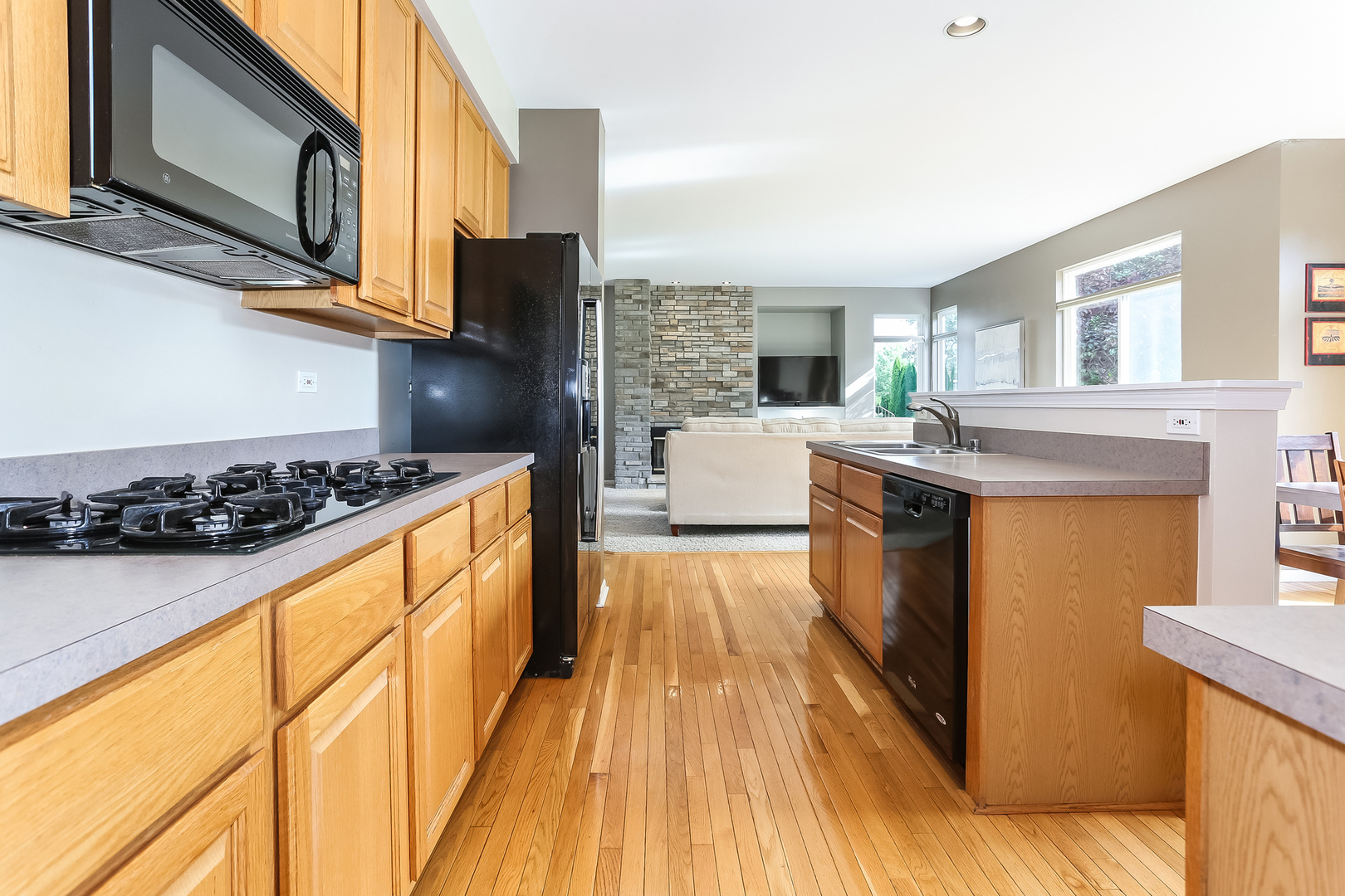 5460 Sullivan Pass Lake In The Hills, IL 60156 - Photo 5 of 51 a kitchen with stainless steel appliances granite countertop a stove and a wooden cabinets