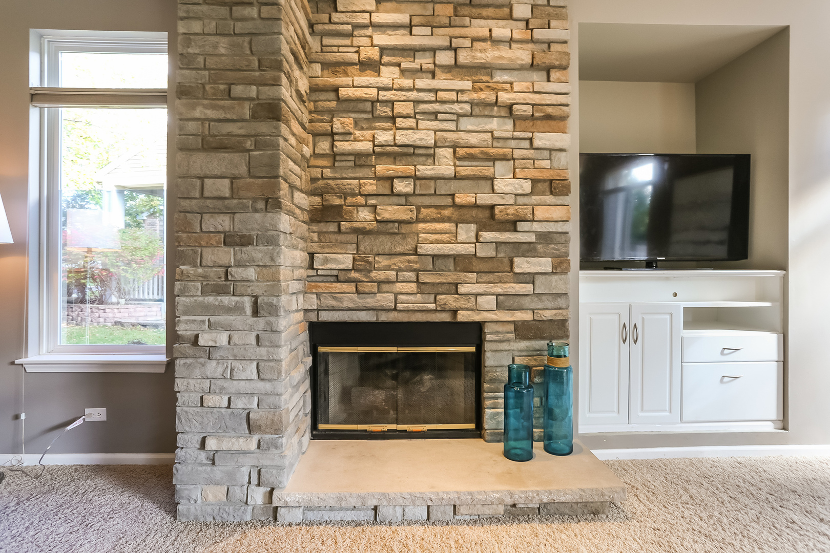 5460 Sullivan Pass Lake In The Hills, IL 60156 - Photo 6 of 51 a living room with a fireplace and a flat screen tv