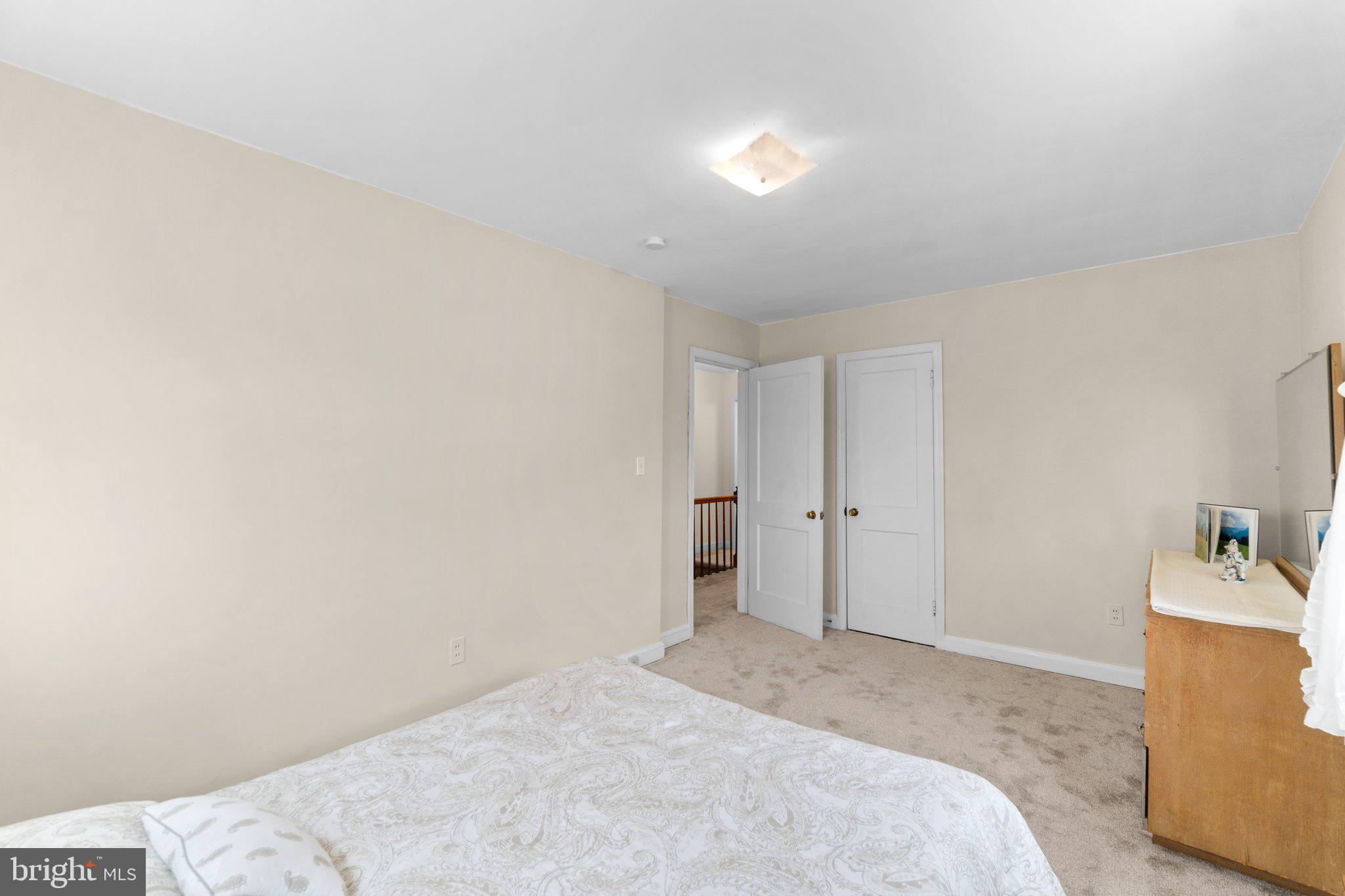2227 Firethorn Road Middle River, MD 21220 - Photo 18 of 27 a spacious bedroom with a bed and a sink