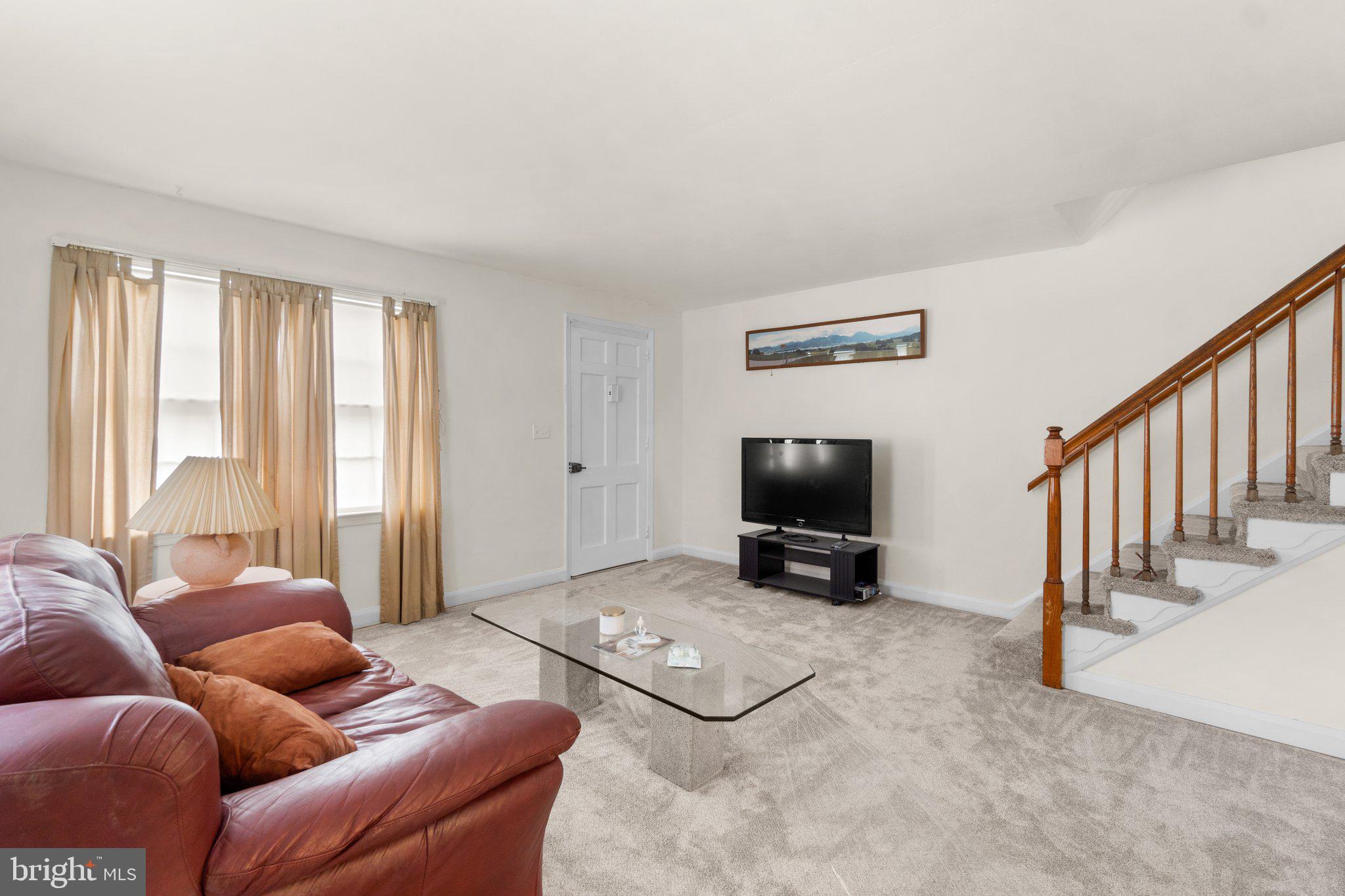 2227 Firethorn Road Middle River, MD 21220 - Photo 2 of 27 a living room with furniture and a flat screen tv