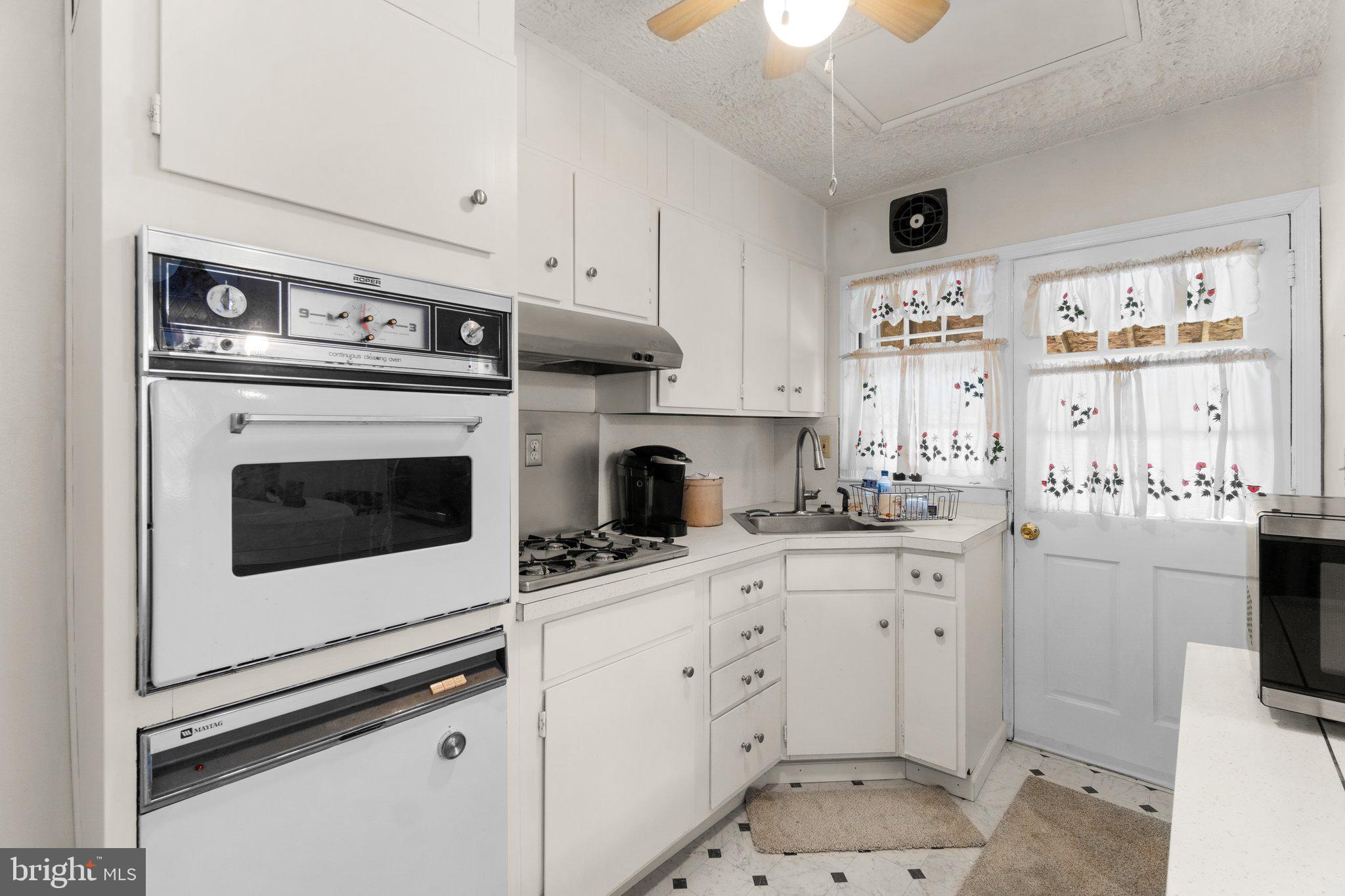 2227 Firethorn Road Middle River, MD 21220 - Photo 7 of 27 a kitchen with white cabinets and appliances