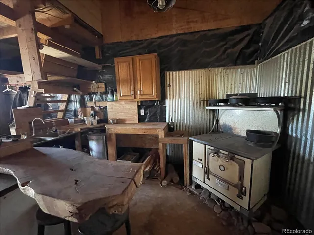 a kitchen with stainless steel appliances granite countertop a stove a sink dishwasher and cabinets with wooden floor