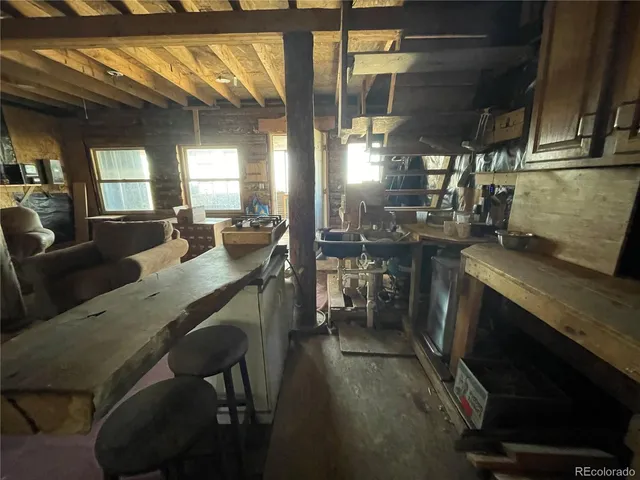 a kitchen with sink dining table and chairs