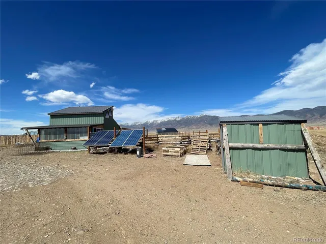 a view of a house with a patio and a yard