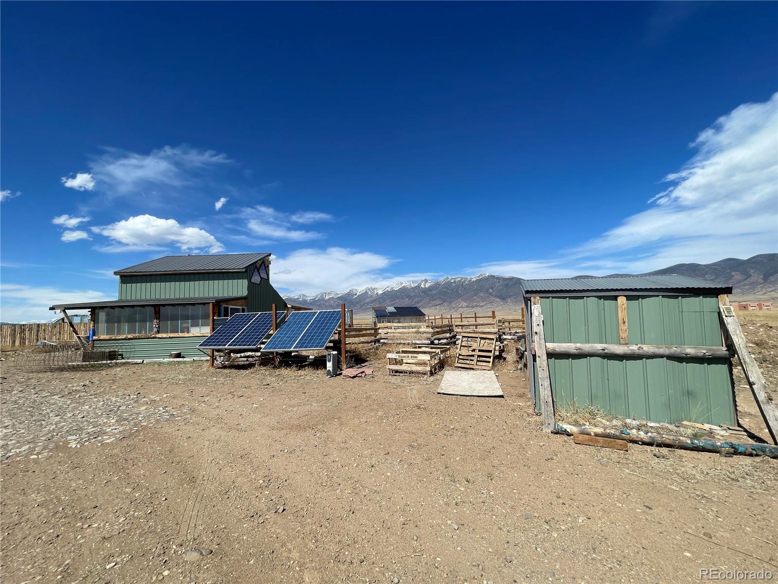 58313 County Road Villa Grove, CO 81155 - Photo 27 of 39 a view of a house with a patio and a yard