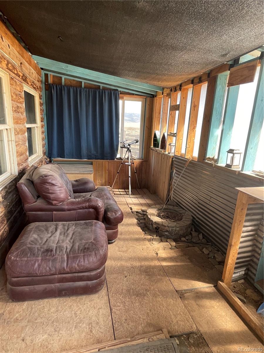 58313 County Road Villa Grove, CO 81155 - Photo 5 of 39 a living room with furniture and a fireplace