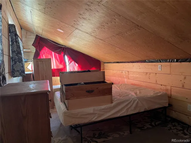 a room with pool table and chairs