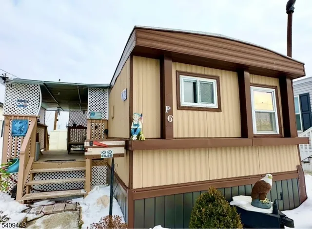 a front view of a house with outdoor seating