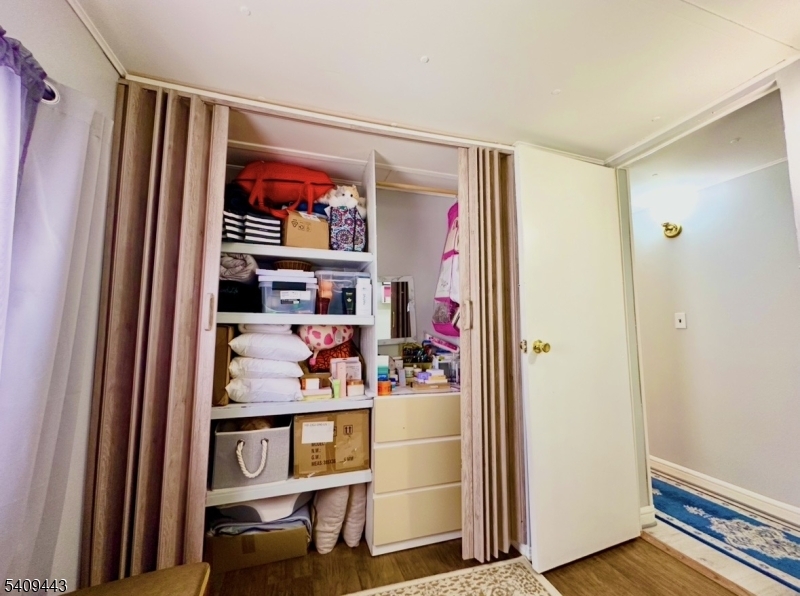 26 Dalbert Street Carteret, NJ 07008 - Photo 14 of 34 a view of walk in closet with clothes and shoes