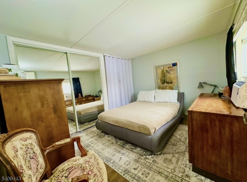 26 Dalbert Street Carteret, NJ 07008 - Photo 21 of 34 a bedroom with a bed and wooden floor