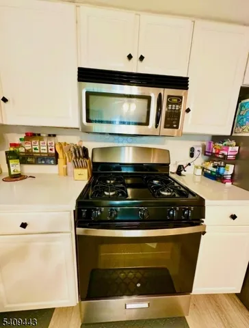 a stove top oven sitting inside of a kitchen