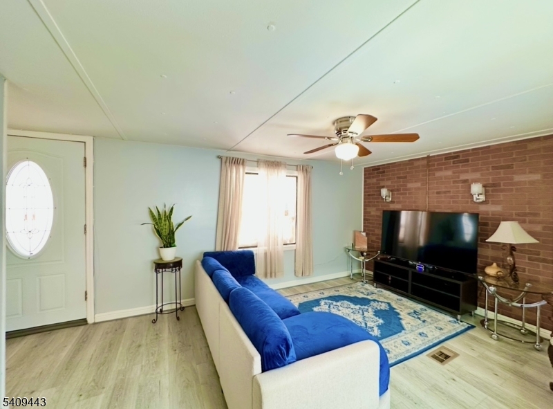 26 Dalbert Street Carteret, NJ 07008 - Photo 9 of 34 a living room with furniture and a flat screen tv
