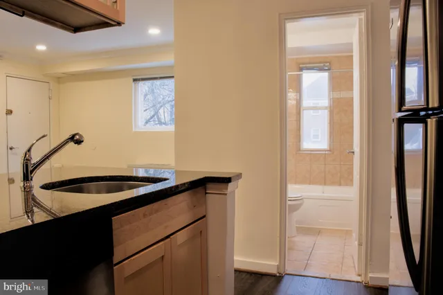 a kitchen with sink and cabinets