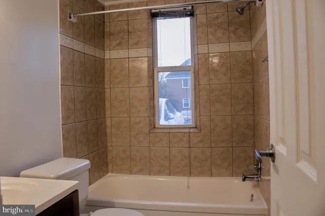 a bathroom with a shower and a bath tub
