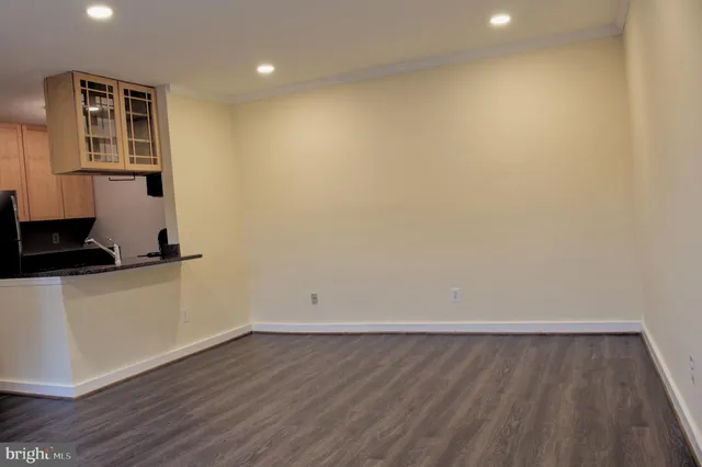 a view of storage and utility room with wooden floor