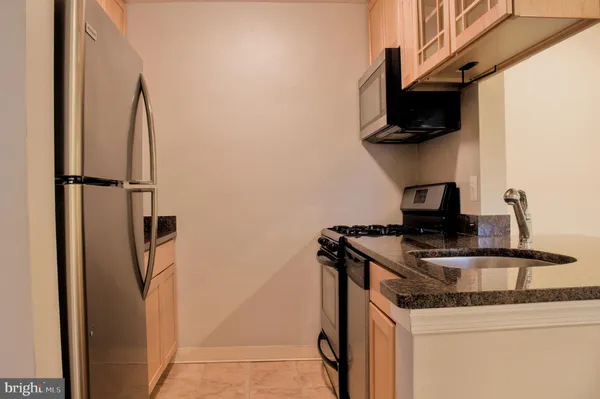 a kitchen with a appliances and cabinets