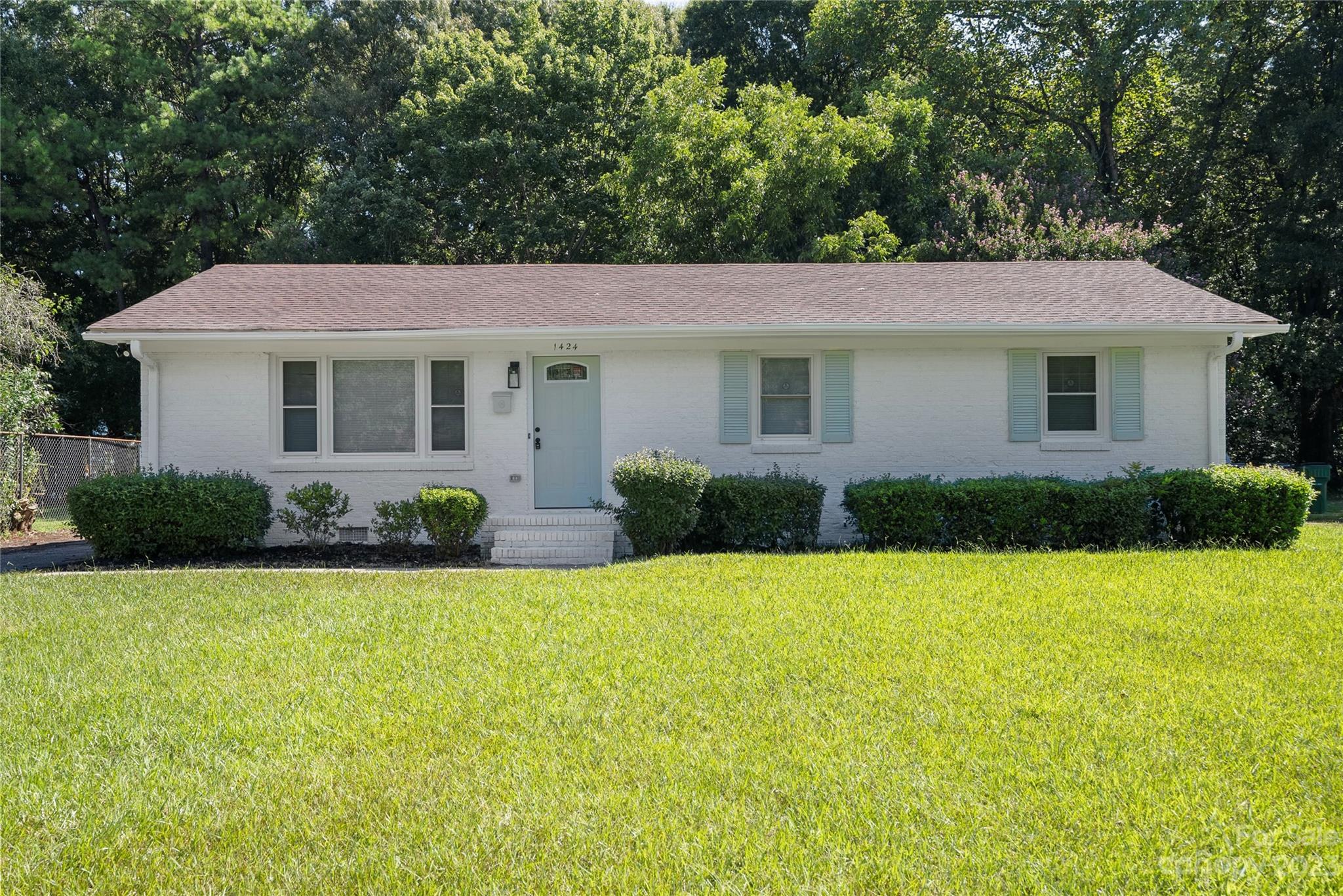 a view of house with a yard
