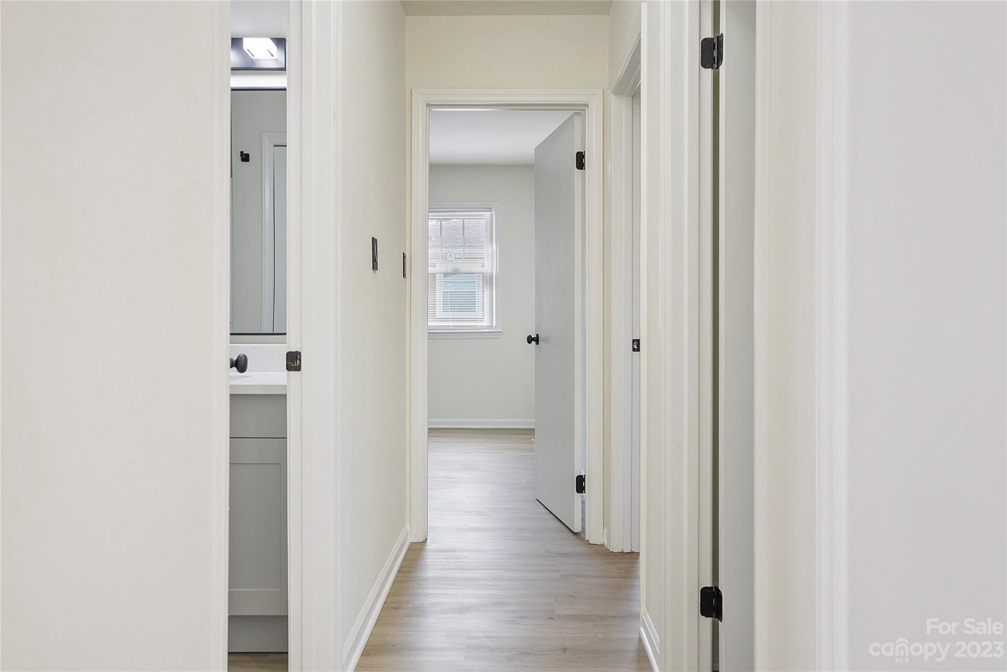 1424 Echo Glen Road Charlotte, NC 28213 - Photo 13 of 26 a view of a hallway with wooden floor