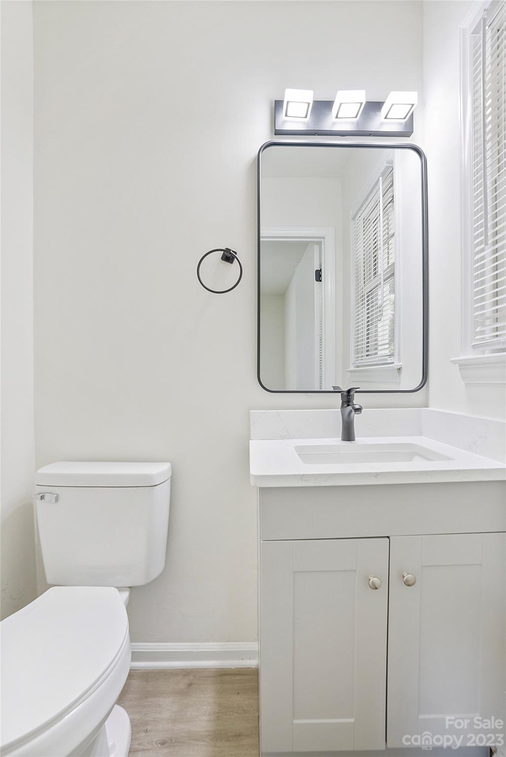 1424 Echo Glen Road Charlotte, NC 28213 - Photo 25 of 26 a bathroom with a toilet a sink and mirror