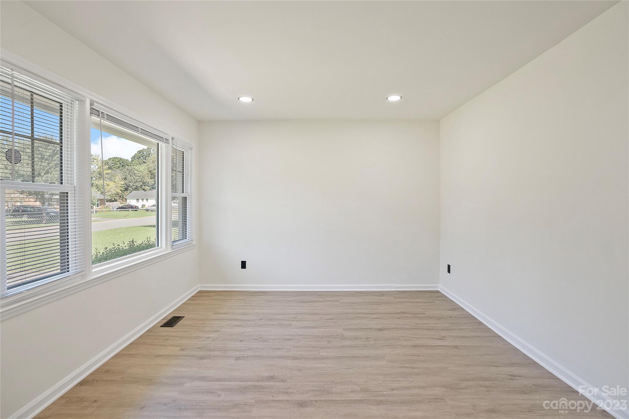 1424 Echo Glen Road Charlotte, NC 28213 - Photo 6 of 26 a view of empty room with wooden floor and fan